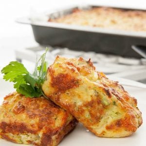 Close up view of individual zucchini slice on white plate and background