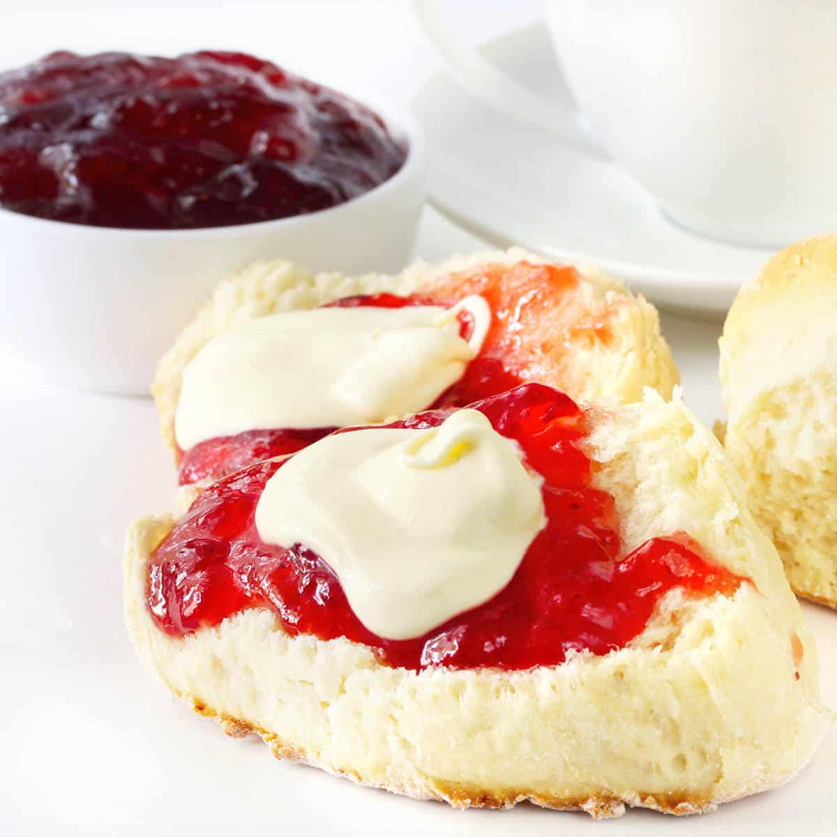 Scones with Jam and Cream on white background