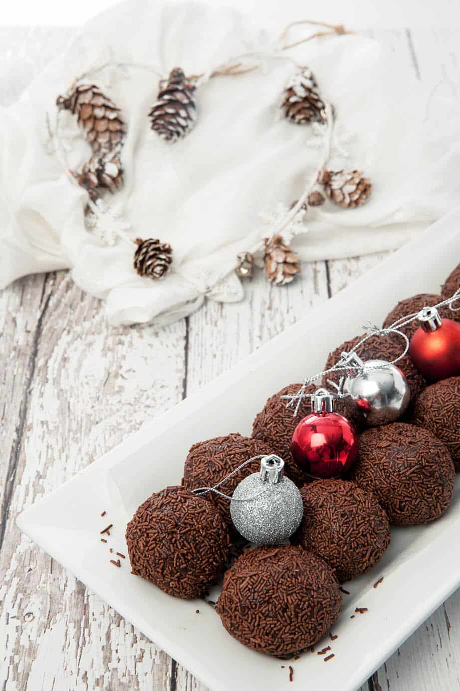 Chocolate Rum Balls Thermomix on a plate with Christmas decorations