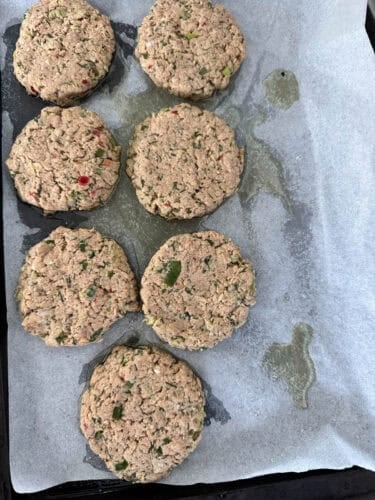 Salmon Burgers formed and ready for baking on a tray