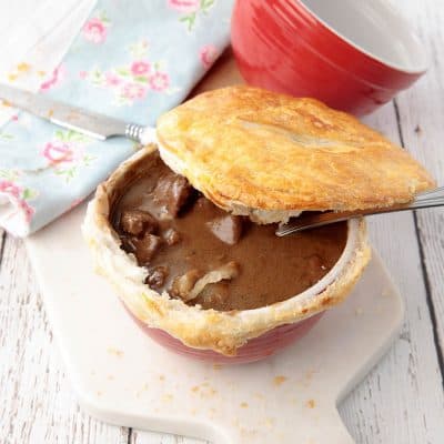 Homemade Guinness Pot Pie with pastry lifted to reveal the filling