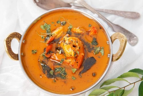 Indian prawn curry in a bowl with garnish