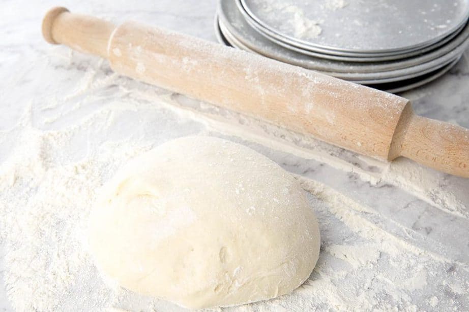 Image of homemade dough being rolled for Pizza