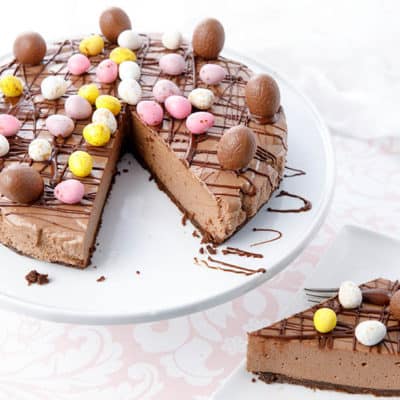 Thermomix chocolate cheesecake with a slice on a plate decorated in Easter Eggs