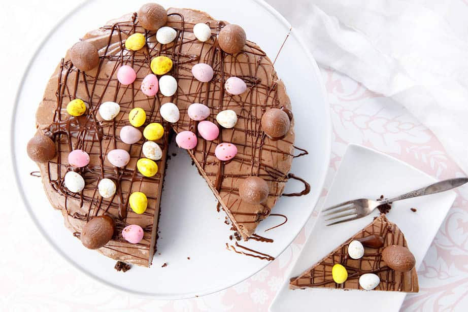 Overhead shot of chocolate cheesecake with Easter Eggs on top to decorate