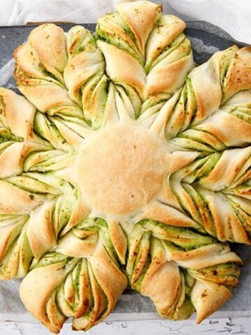 Overhead shot of cheese garlic bread shaped into a braided star