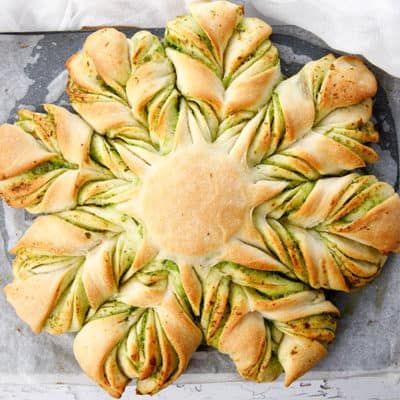 Overhead shot of cheese garlic bread shaped into a braided star