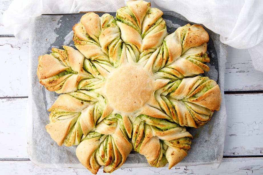 Overhead shot of cheese garlic bread shaped into a braided star