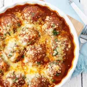 Overhead shot meatballs in tomato sauce on white background