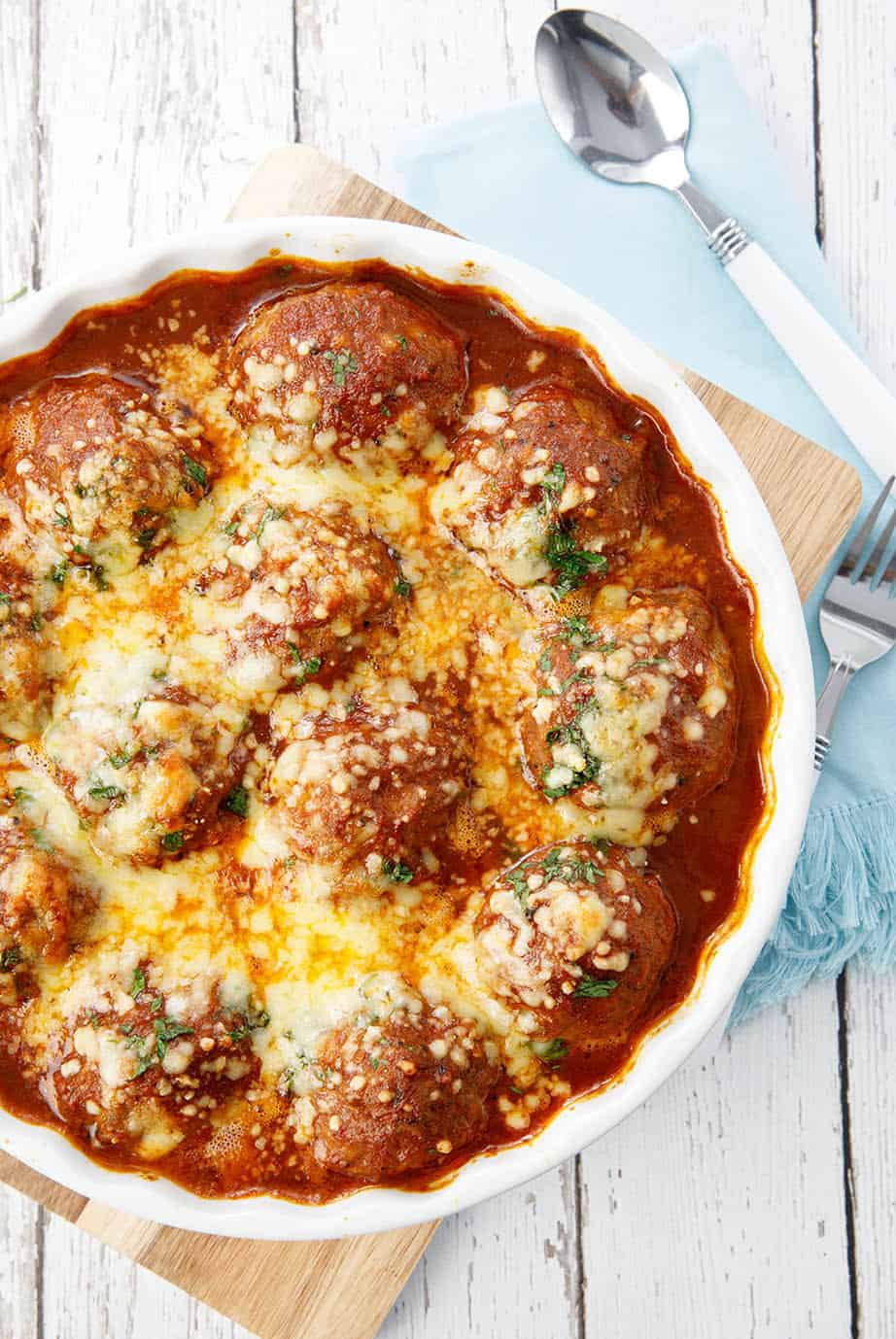 Overhead shot meatballs in tomato sauce on white background