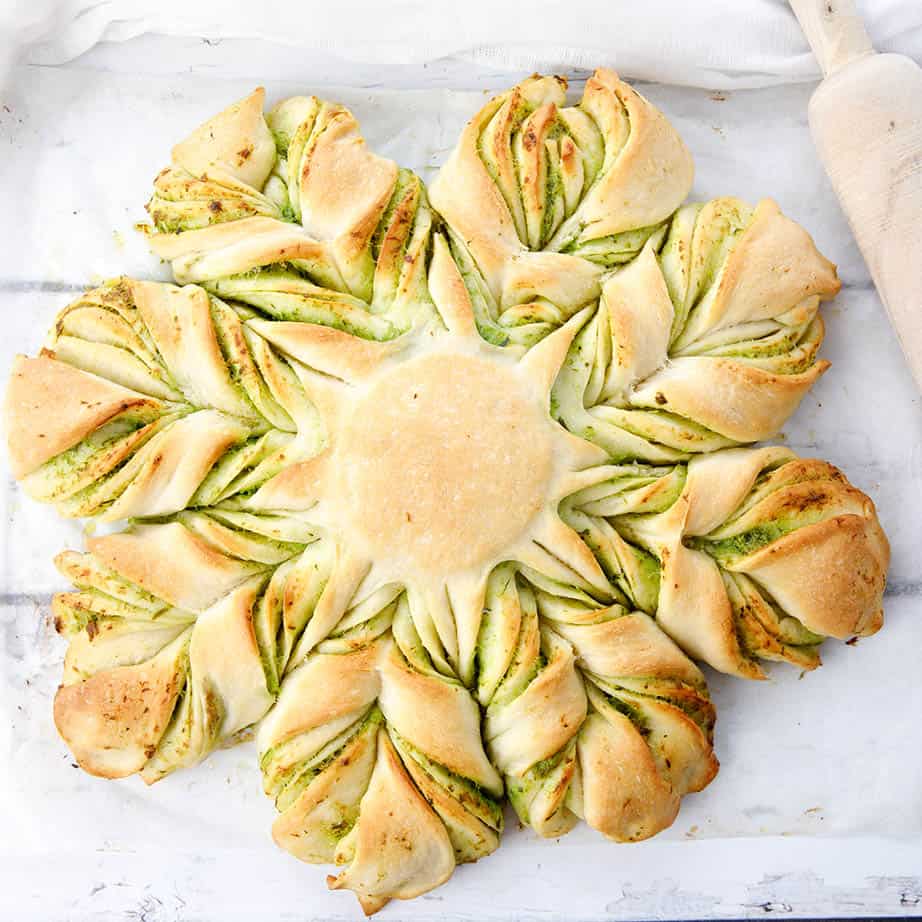 Over head shot of completed garlic bread star bread on white background