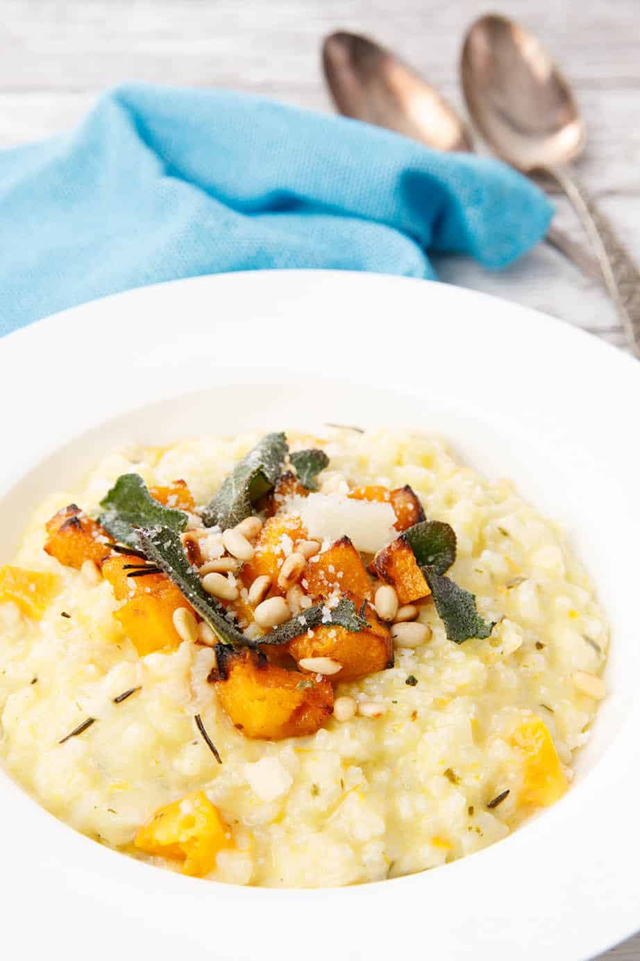 Portrait image of Pumpkin risotto sitting on a blue napkin 