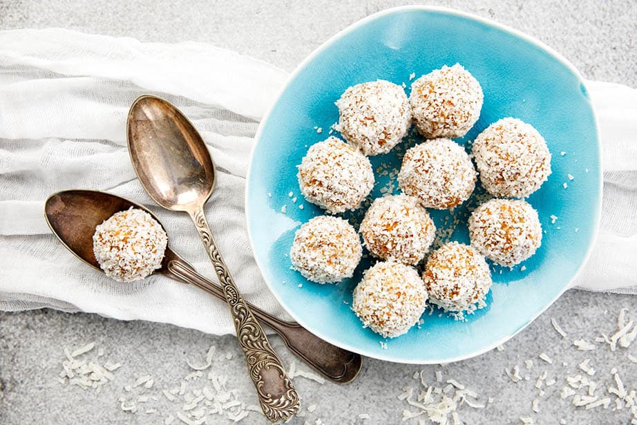 Overhead landscape image Carrot Cake Protein balls on blue plate