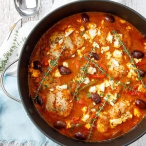 Overhead shot of pot chicken cacciatore on white background