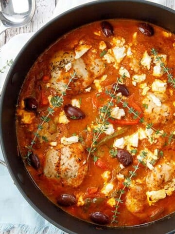 Overhead shot of pot chicken cacciatore on white background