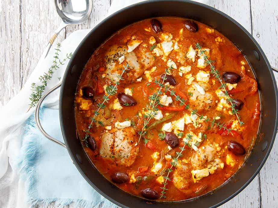 Overhead shot of pot chicken cacciatore on white background