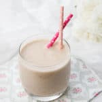 Landscape image of healthy smoothie on a floral napkin and white background