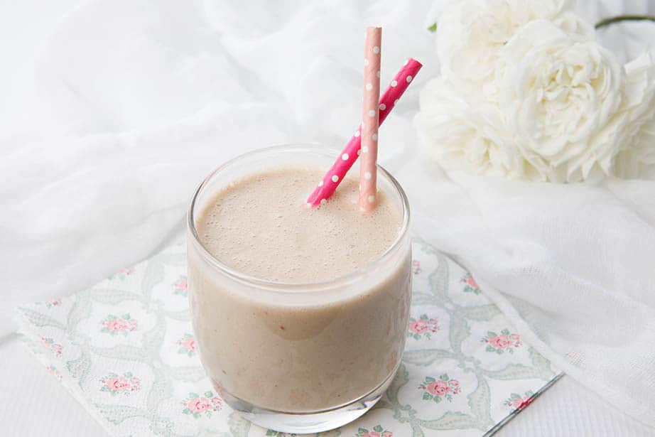 Landscape image of healthy smoothie on a floral napkin and white background