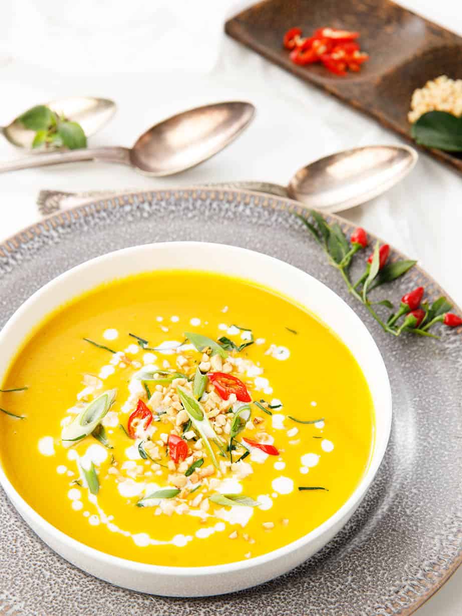 Overhead portrait image of Thai Pumpkin Soup in a white bowl