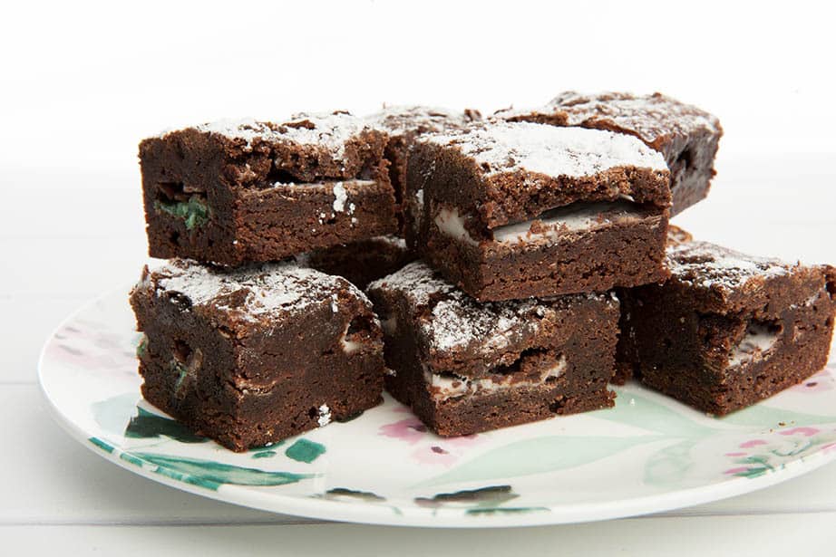 Close up of chocolate mint brownies on a floral plate