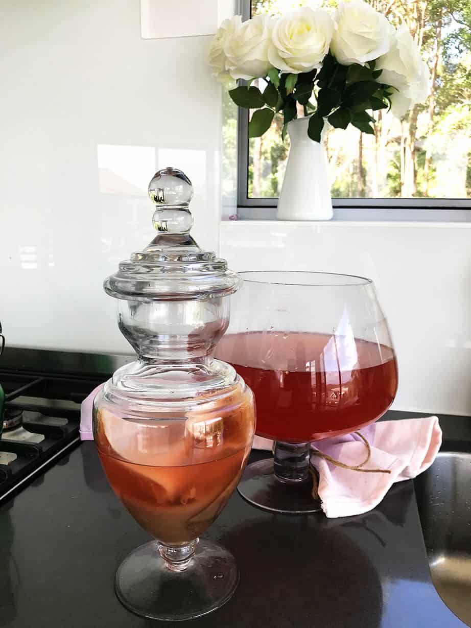 Image brewing kombucha warm on a black kitchen bench