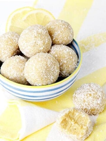 lemon bliss balls on a white background and yellow striped tea towel