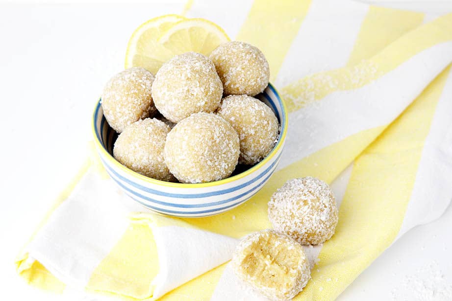 lemon bliss balls on a white background and yellow striped tea towel