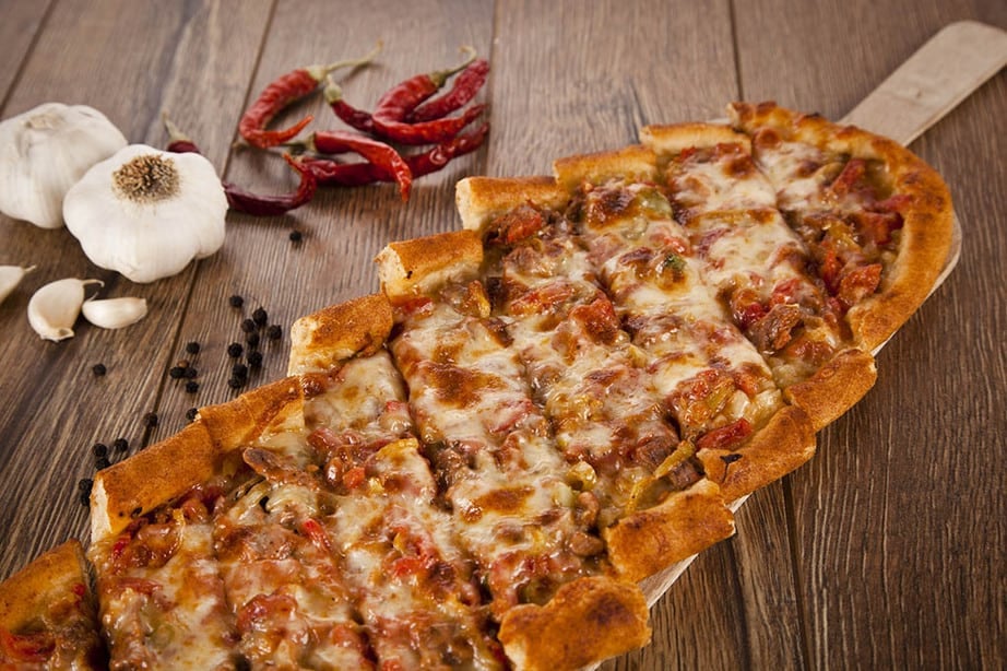 Overhead shot of Turkish Pide on a wooden board