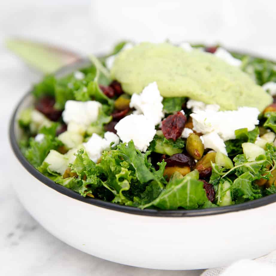 Square image of kale salad with avocado dressing