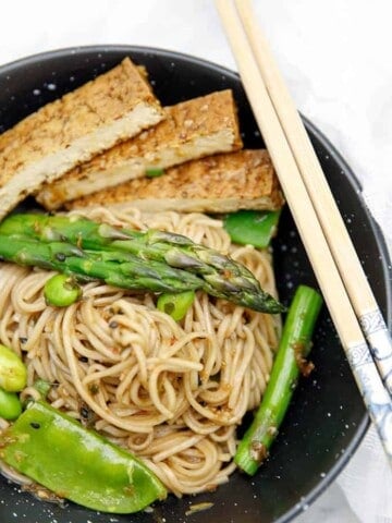 Overhead shot of Soba noodle salad in black bowl