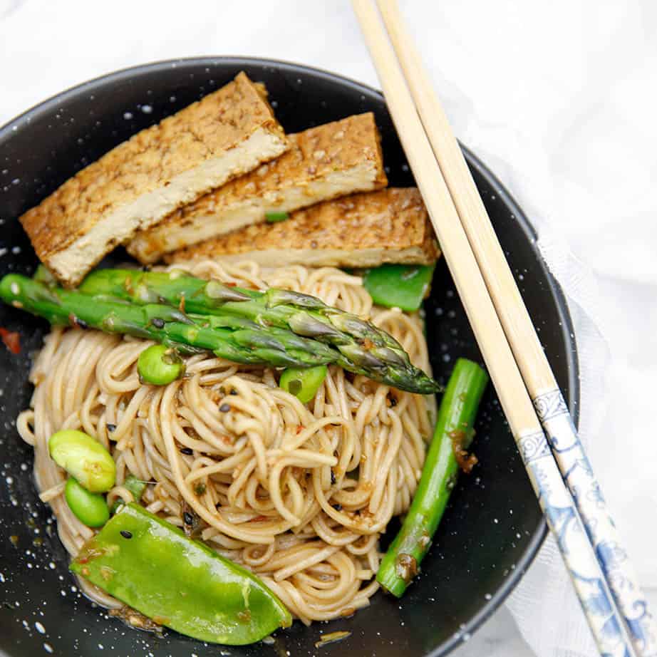 Overhead shot of Soba noodle salad in black bowl