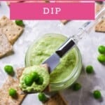 Overhead close up of smashed Bean and Pea Dip and crackers on a grey background