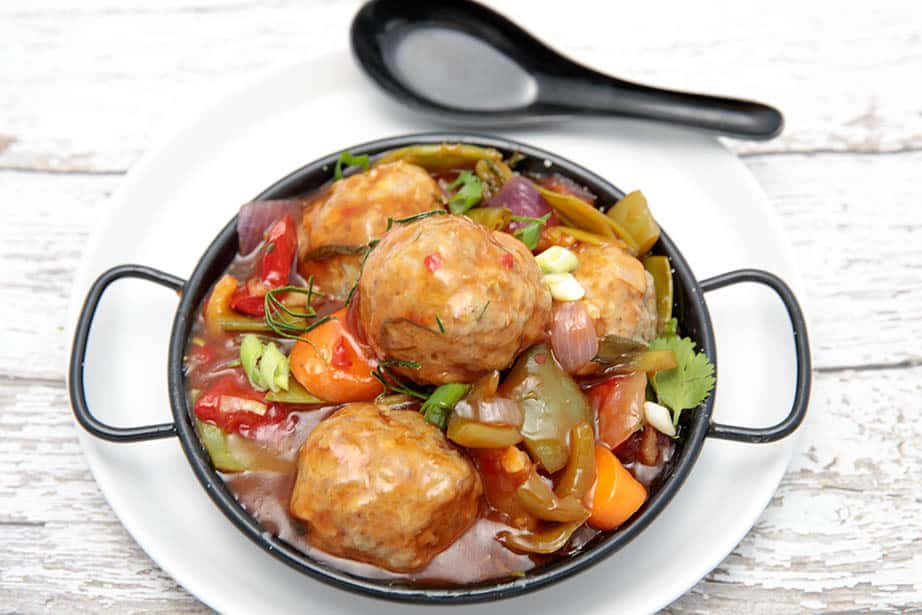 Overhead shot of pork meatballs in a sweet and sour sauce