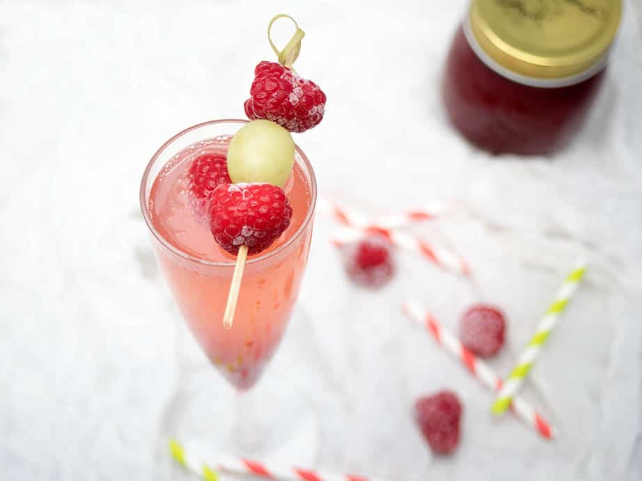 Champagne cocktail with frozen raspberry 