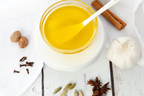 Clarified butter made into an Indian spiced ghee on a white background