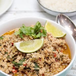 Thai Chicken larb in bowl on light wooden background