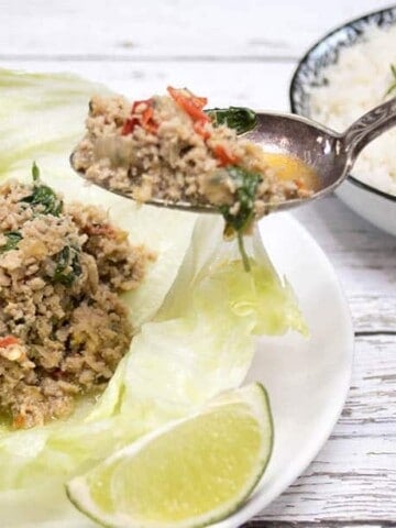 Chicken Larb being spooned into lettuce cups