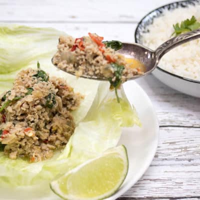 Chicken Larb being spooned into lettuce cups