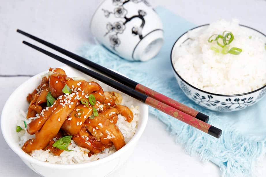 Teriyaki Chicken on a white background with rice and chopsticks