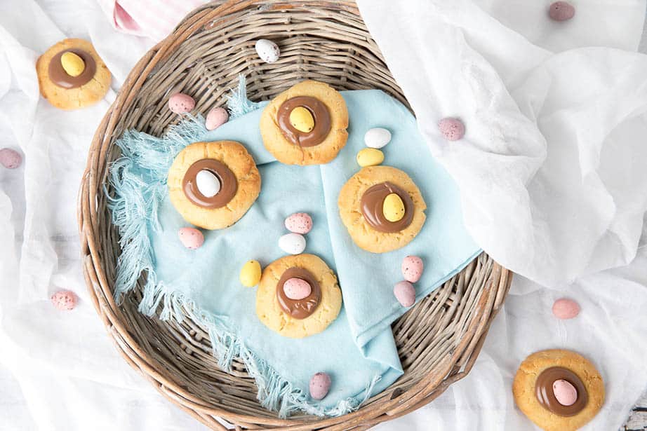 Overhead shot of Easter Cookies in a basket with a blue napkin