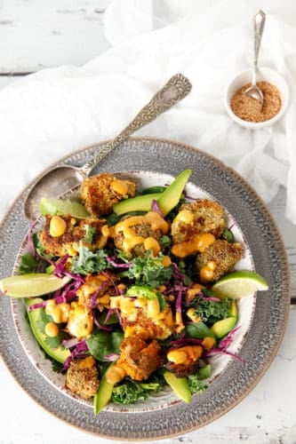 Overhead shot Keto Popcorn Chicken salad with sprinkles on white background