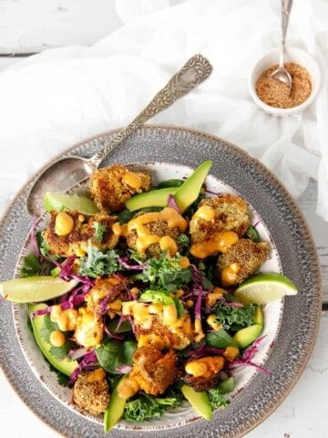 Overhead shot Keto Popcorn Chicken salad with sprinkles on white background