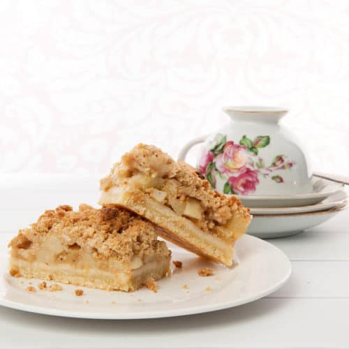 Square image of apple streusel on a white background
