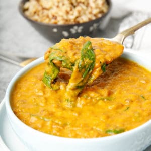 Close up Thermomix lentil soup with pumpkin and spinach on white cloth