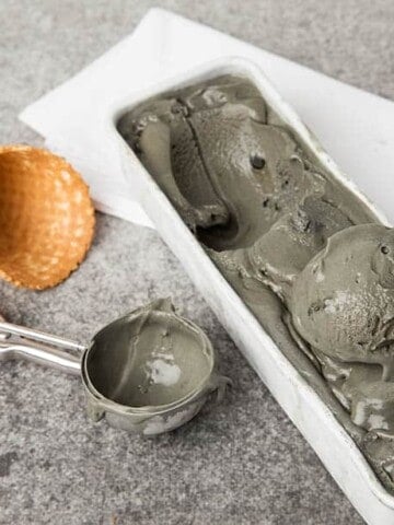 Landscape image licorice ice cream in metal dish on grey background