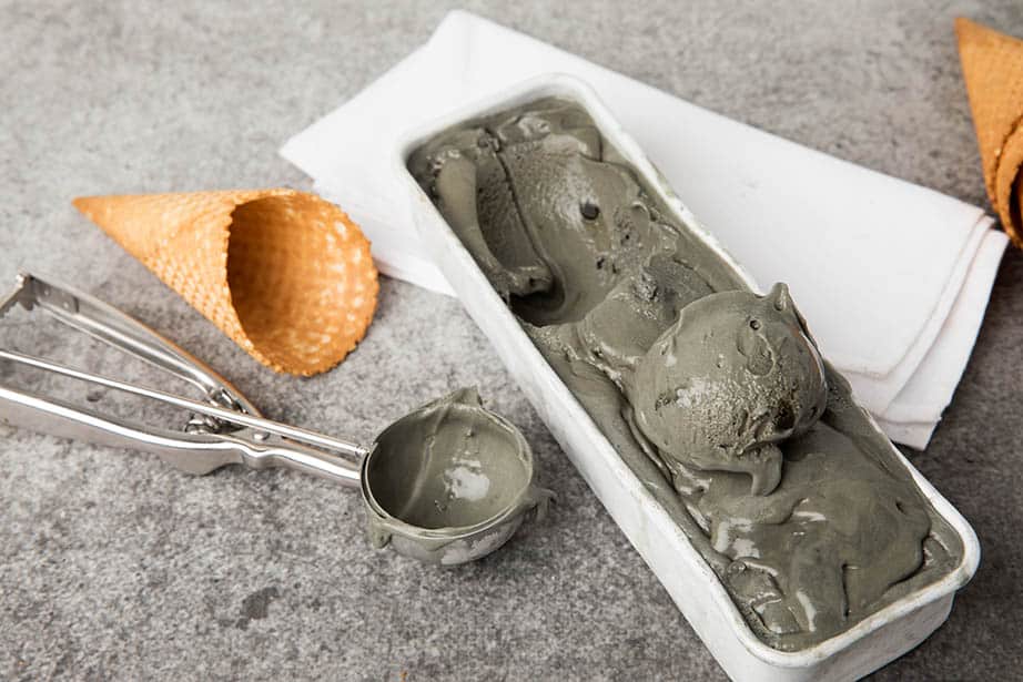 Landscape image licorice ice cream in metal dish on grey background