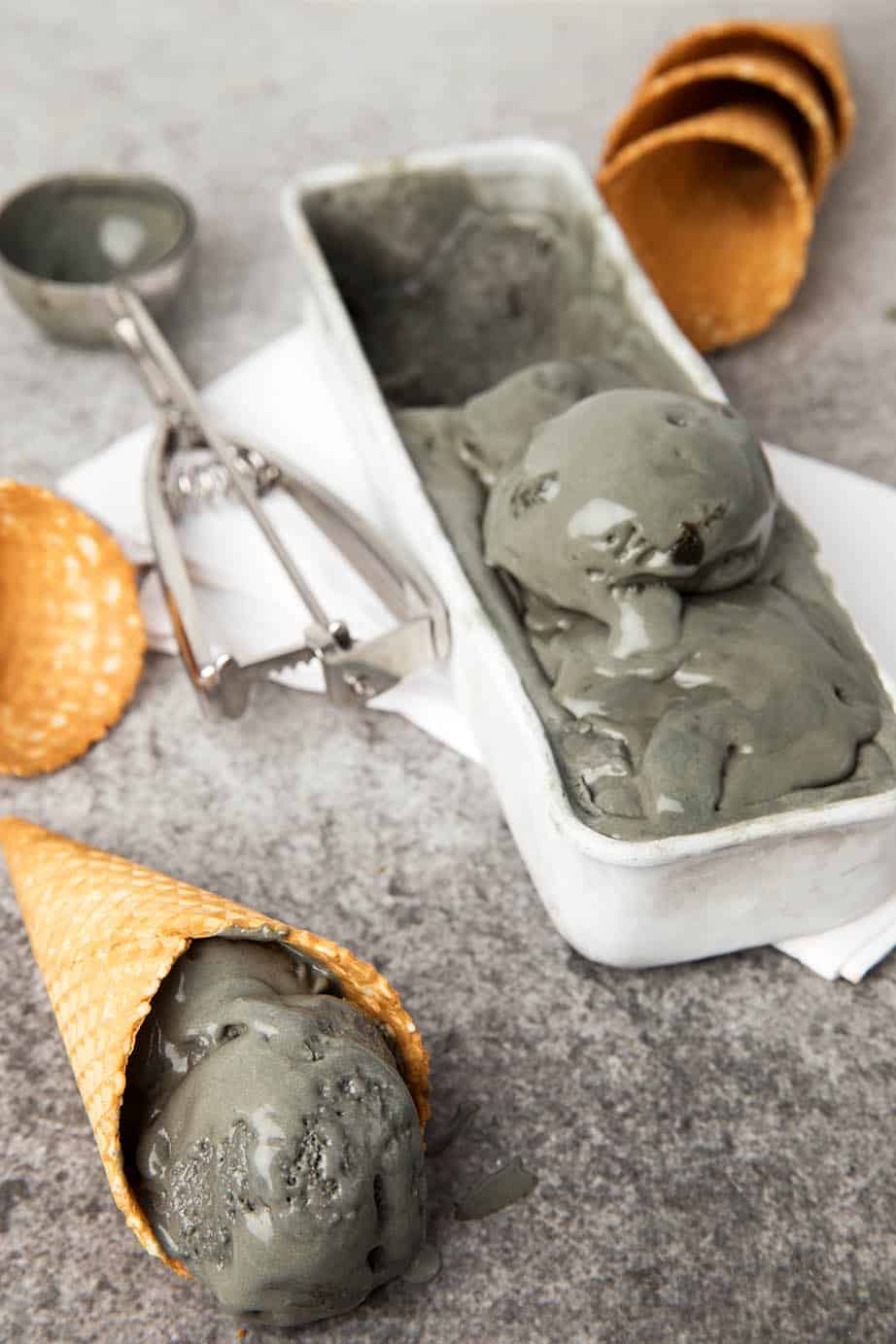 Ice cream cones with licorice ice cream on a dark background