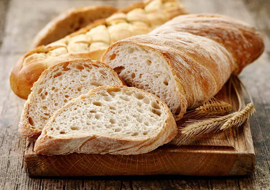 Various different styles of breads on a chopping board