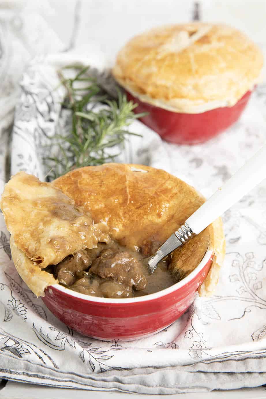 Two Peppercorn pot pies one with the pastry removed