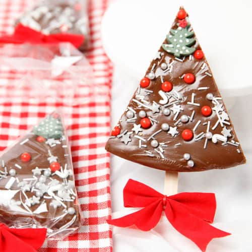 Peppermint chocolate fudge in the shape of a Christmas tree on white and red background